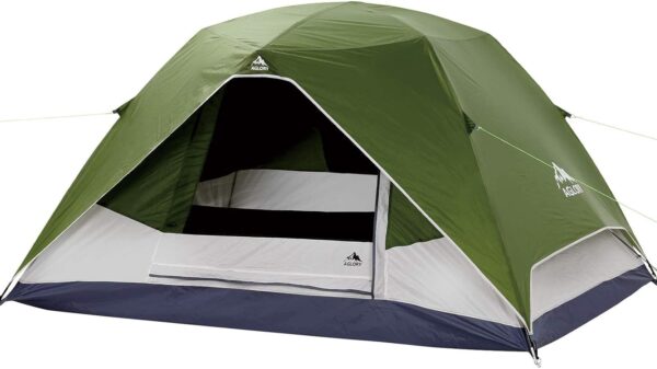 A green and white tent with an open door.