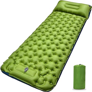 A green sleeping pad with a pillow on top of it.