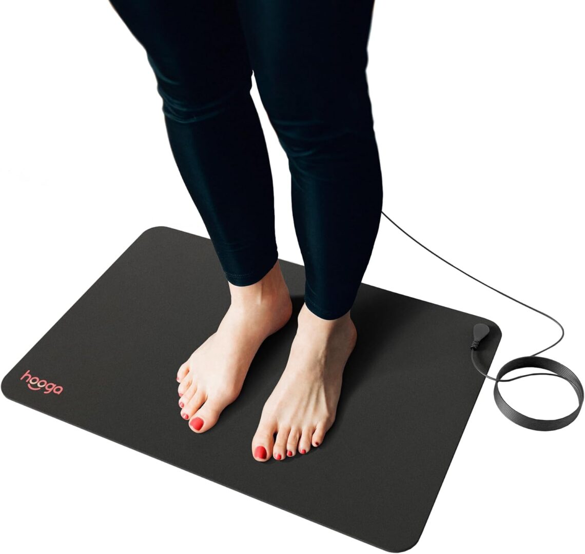 A person standing on the floor with their feet on a mat